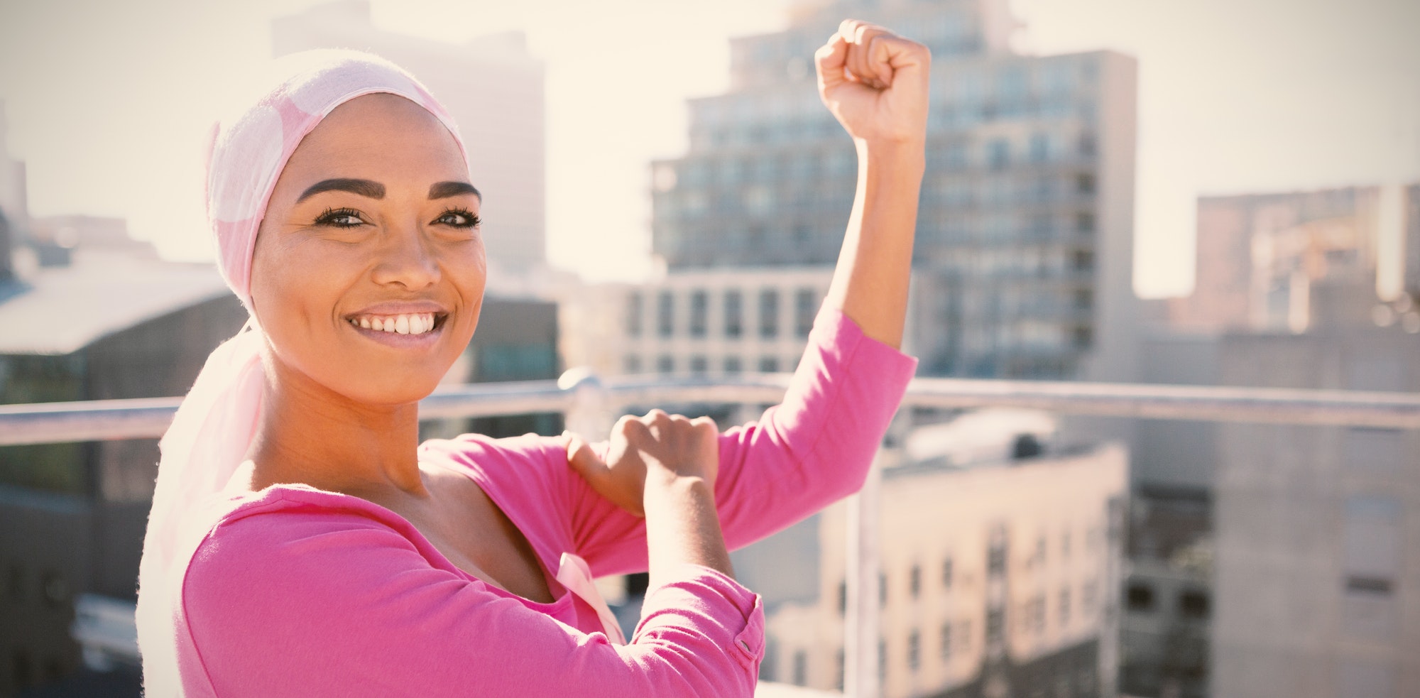 Strong woman in city with breast cancer awareness